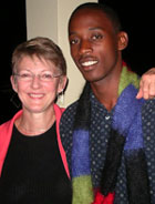 Geofrey Katsushabe and Cari take a moment to show off the Rwandan Scarf for Peace